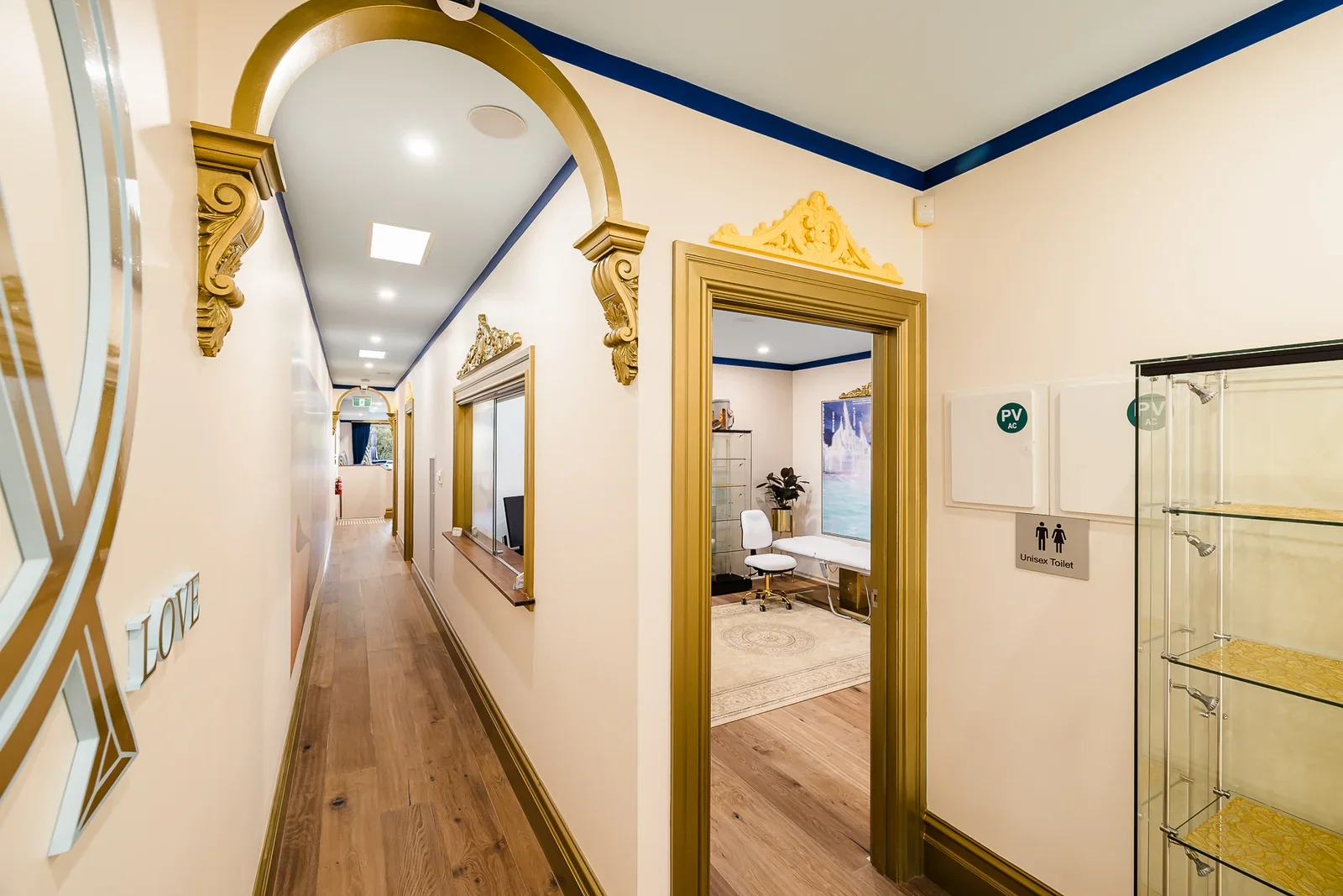 Inside Atlantis Centre, with gold-trimmed archways and a bright hallway beside the reception counter