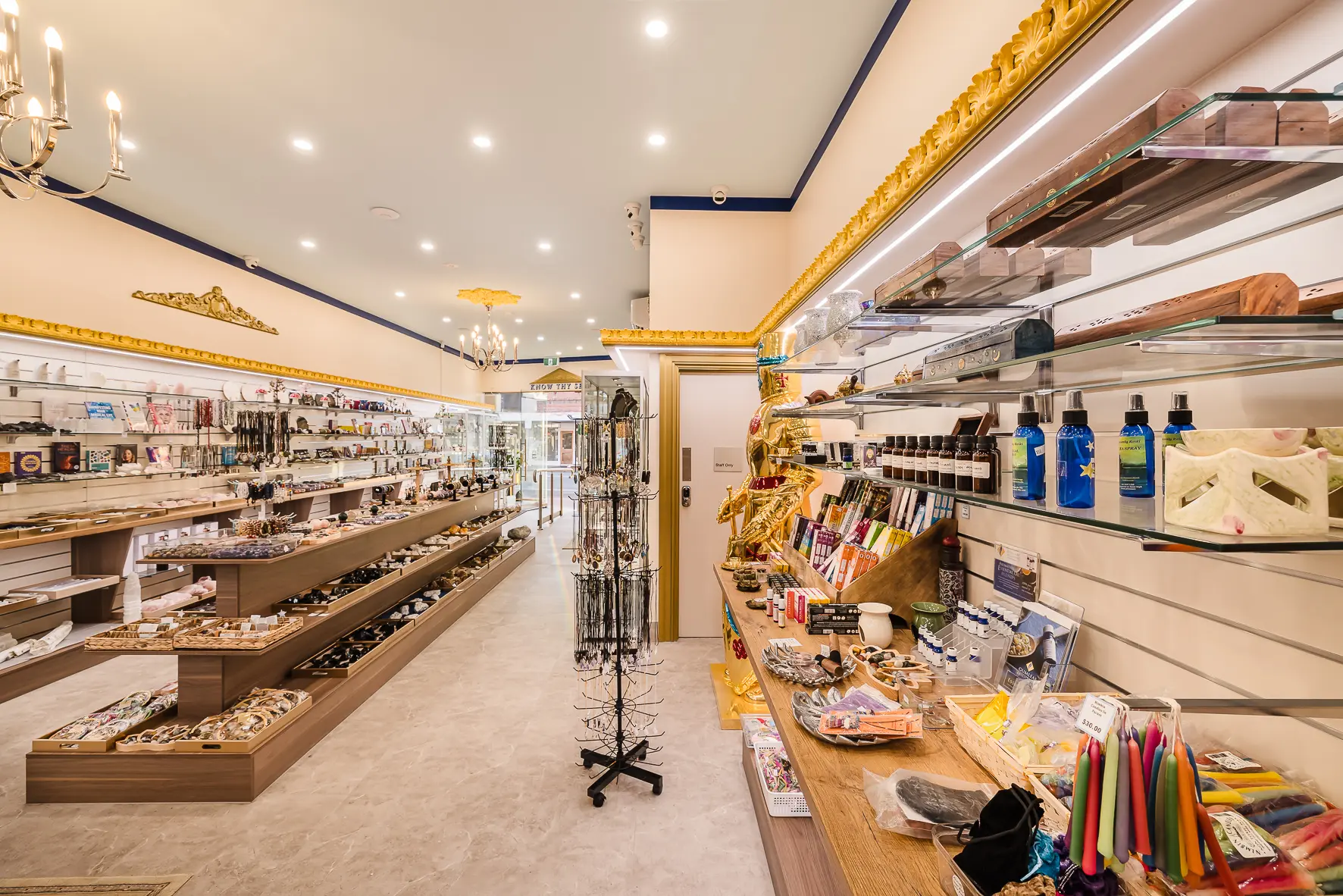The service counter at the Atlantis Centre Crystal Gift Shop, with crystal trees and gifts on the mirrored shelving behind it