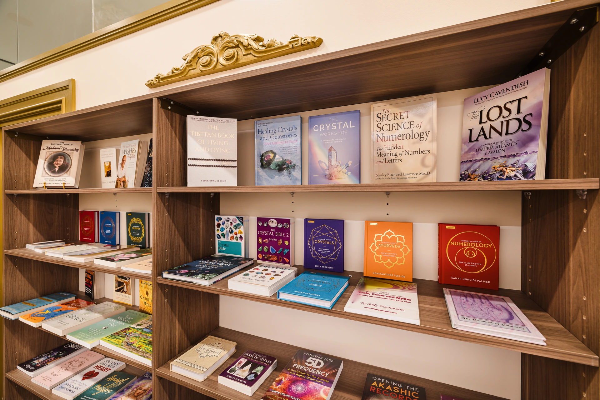 Books on spiritual enquiry and personal reflection on a wooden bookcase inside Atlantis Centre