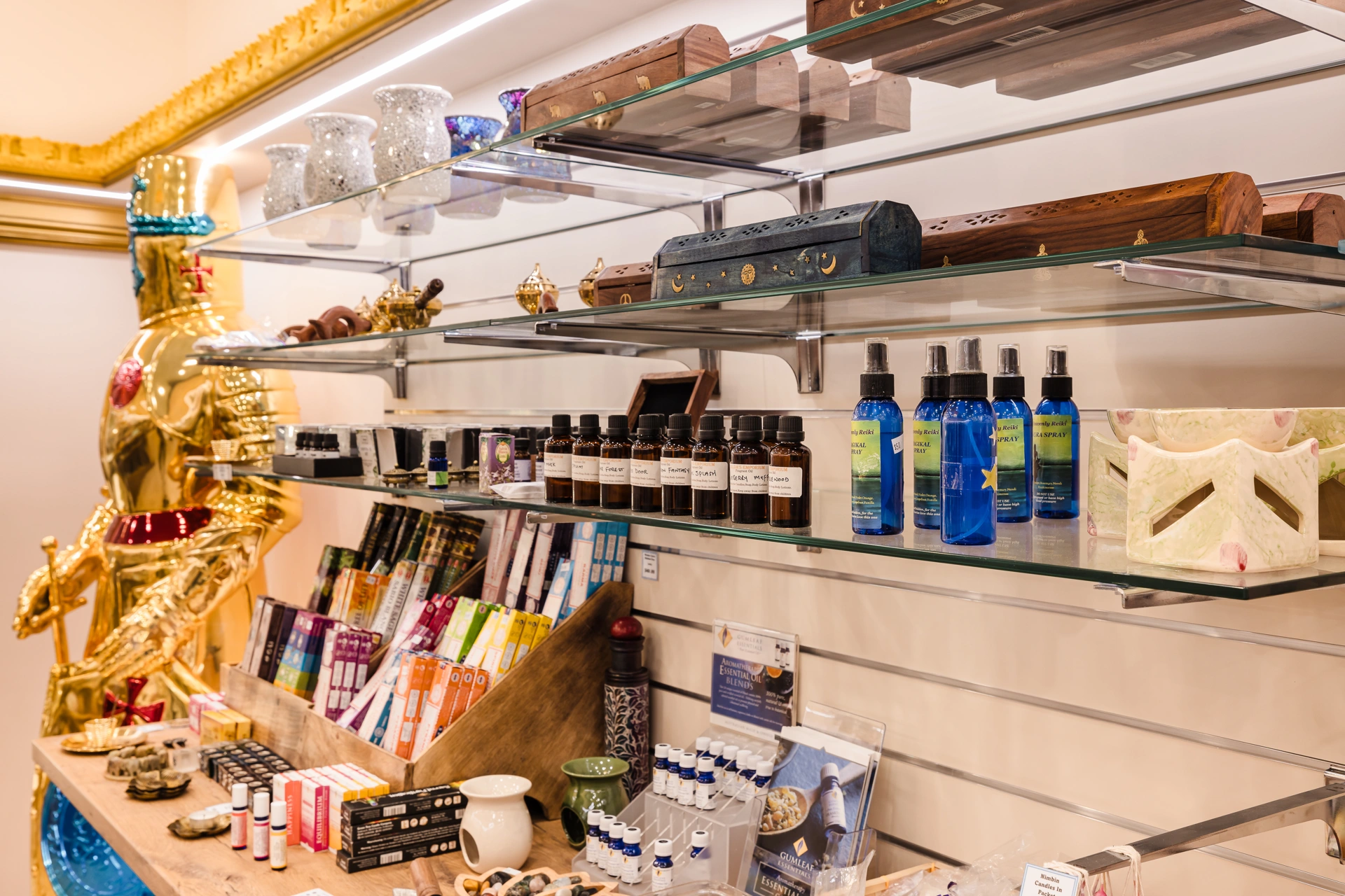 Incense, essential oils, oil burners and gifts displayed on glass shelves inside Atlantis Centre