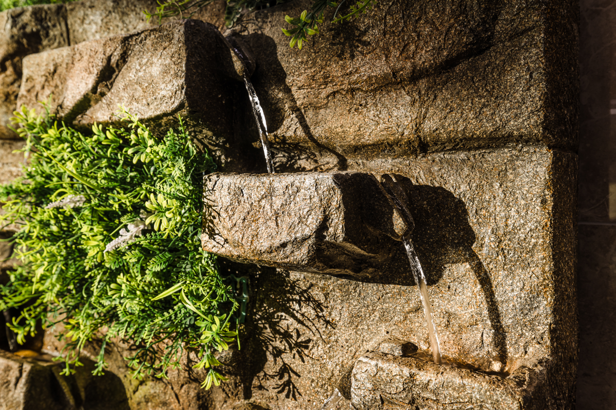 Natural stone and flowing water in the Atlantis Centre indoor water feature