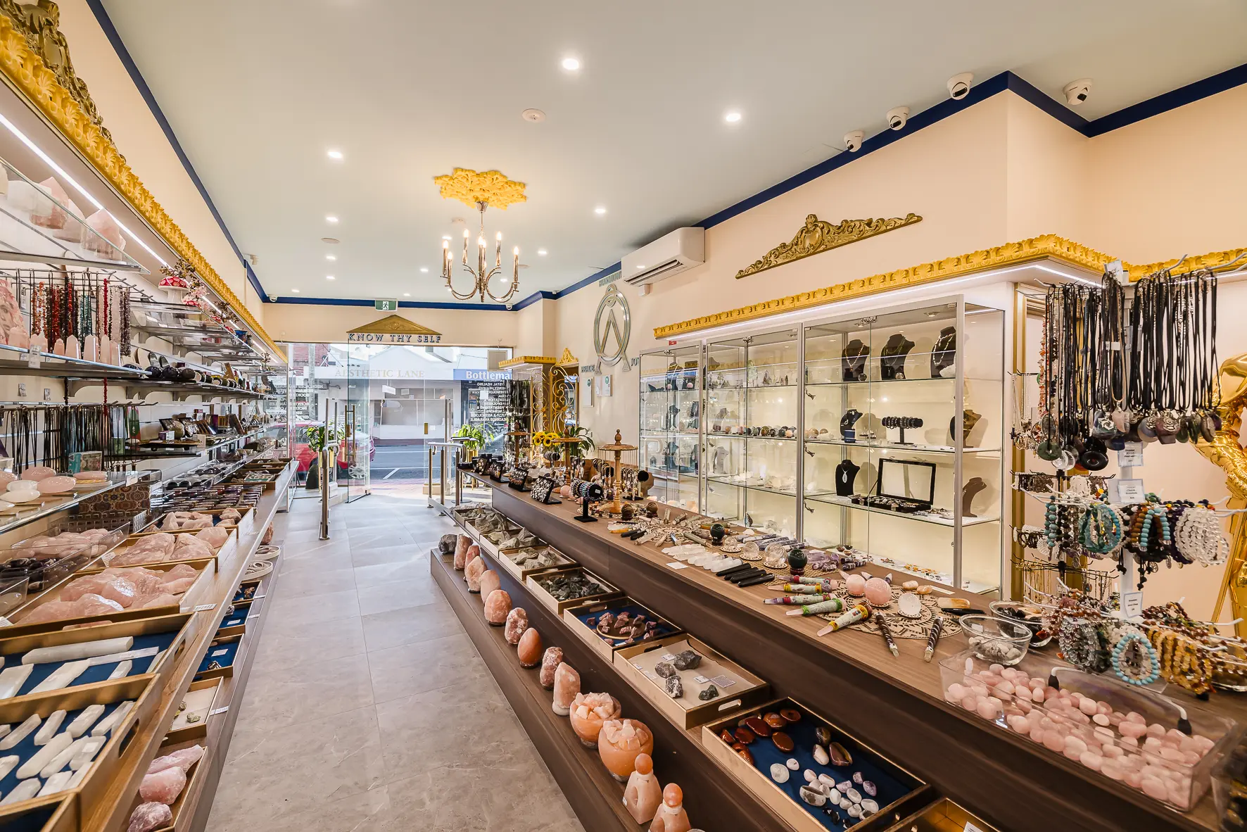 The Atlantis Centre Crystal Gift Shop looking towards the street entrance, with crystals, jewellery and gemstones on display along both sides